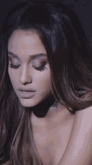 a close up of ariana grande 's face with her eyes closed