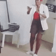 a woman is dancing in a room with a go away sign on the door .