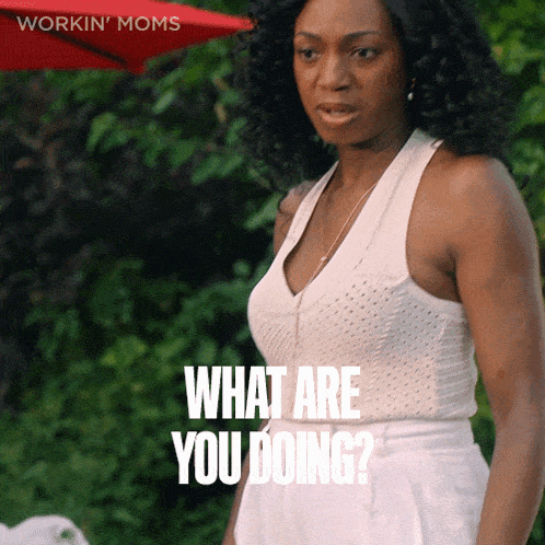 a woman stands in front of a red umbrella and says " what are you doing "