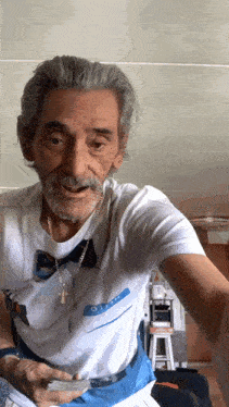 an older man wearing a name tag that says hello