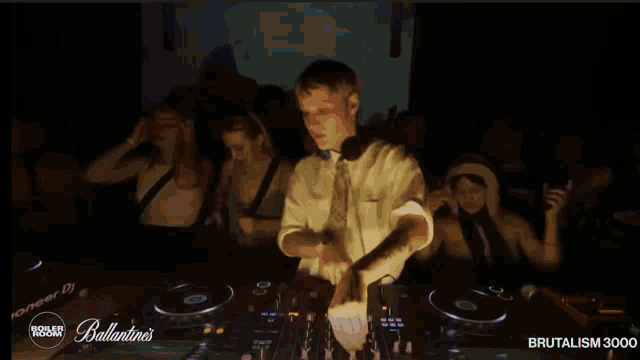 a man is playing music in front of a crowd at a ballantine 's party