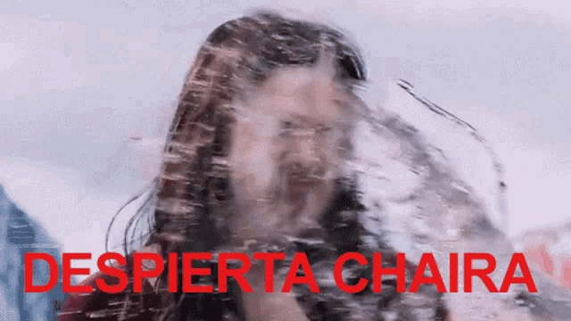 a woman 's face is splashed with water with the words despierta chaira in red