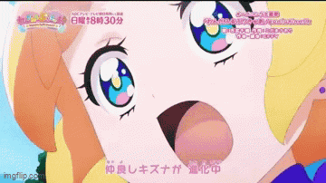 a close up of a cartoon girl 's face with japanese writing