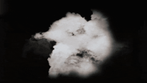 a black and white photo of a cloud in a dark sky