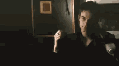 a man is looking at himself in a mirror .