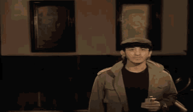 two men are standing next to each other in front of a painting