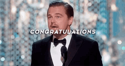 leonardo dicaprio is wearing a tuxedo and bow tie and is giving a speech .