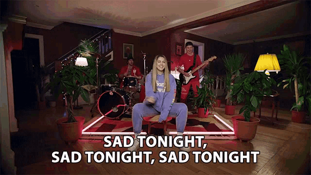 a group of people playing instruments in a living room with the words sad tonight sad tonight written above them