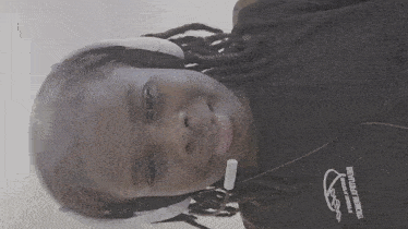 a woman wearing headphones and a black shirt that says ' freedom ' on it