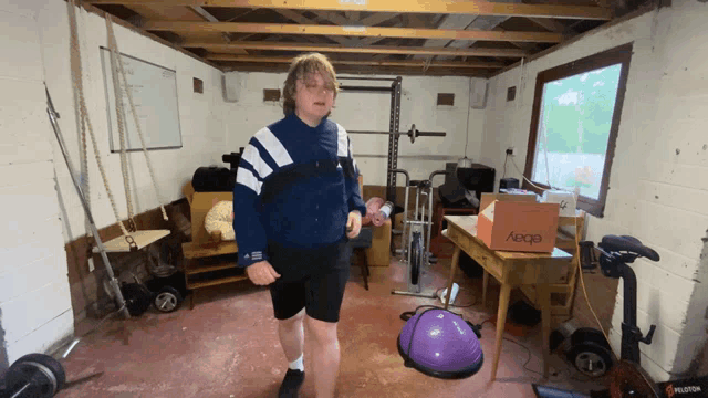 a man standing in a garage with a box that says ebay