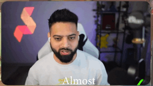 a man with a beard wearing a white shirt with the word almost on it