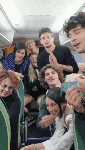 a group of people sitting on a bus with the word fratello on the bottom left