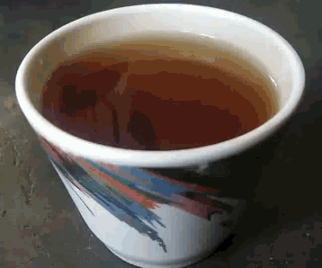 a cup of tea with a colorful design on the side