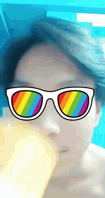 a man wearing a pair of sunglasses with rainbow lenses