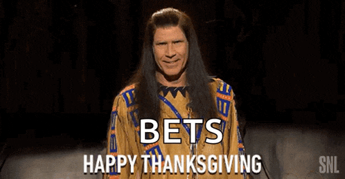 a man in a native american outfit is standing on a stage .