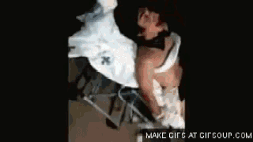 a gif of a person laying on a bed with the words " minha vida " on the bottom