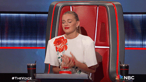 a woman is sitting in a chair with a nbc logo on the bottom