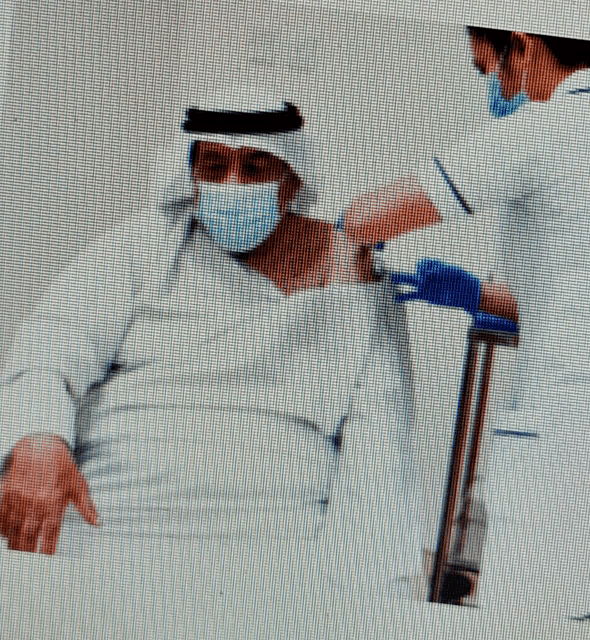 a man wearing a face mask is getting a vaccine