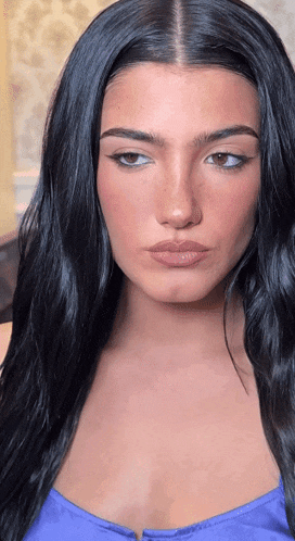 a close up of a woman 's face with long black hair