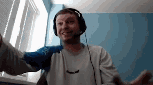 a man wearing headphones and a shirt that has the word babolat on it