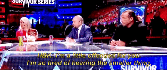 a group of people are sitting at a table with a sign that says survivor series on it