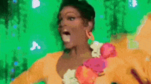 a woman in a yellow dress is dancing on a green screen .