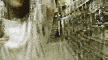 a blurred image of a person walking down a hallway