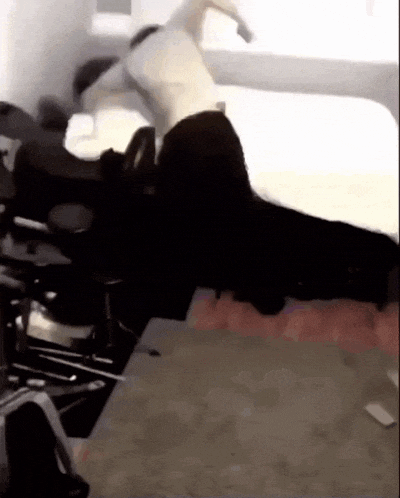 a person is laying on a bed in a room with a chair