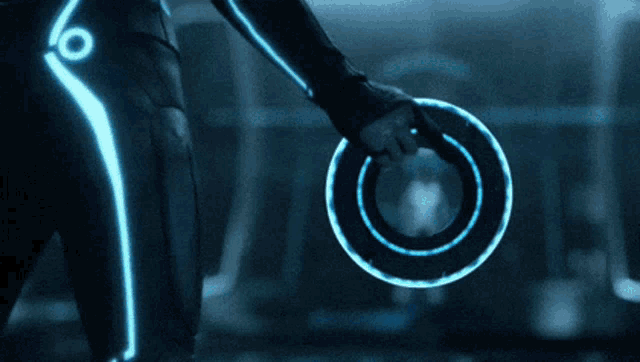 a person is holding a glowing circle with the letter x in the middle