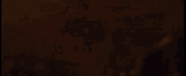 a close up of a man 's face in a dark room