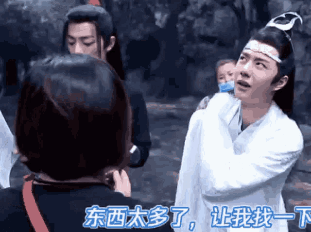 a man in a white robe is talking to a woman in a foreign language