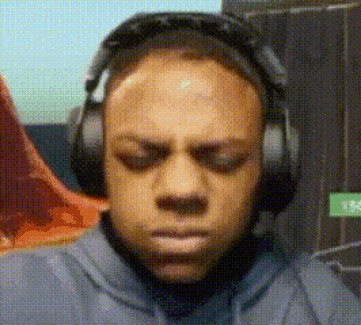 a man is wearing headphones and making a face