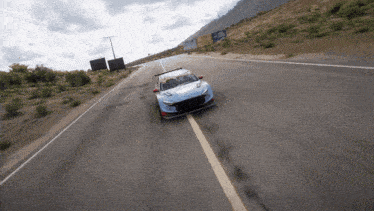 a race car is driving down a road with a sign in the background that says ' hyundai '