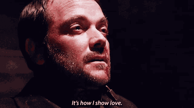 a close up of a man 's face with the words it 's how i show love