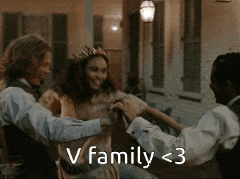 a woman with a crown on her head is dancing with two men with the caption v family < 3
