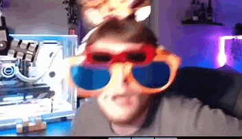 a man wearing a pair of sunglasses is sitting in front of a computer .