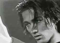a close up of a person 's face with a reflection of another person