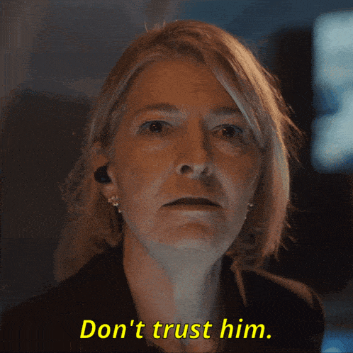 a woman says " don 't trust him " in a dark room