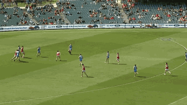 a group of soccer players are playing on a field with an advertisement for maughan thiers