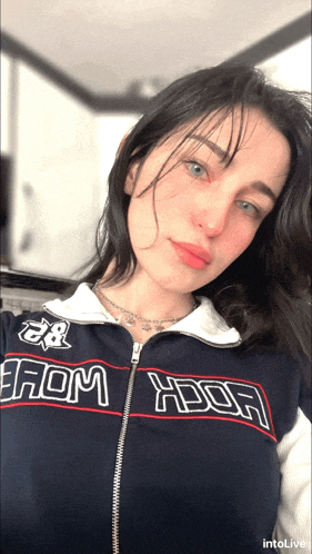 a woman wearing a jacket that says " from ybor "