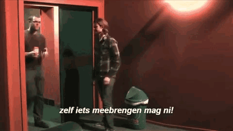 a man standing next to a trash can with the words zelf iets meebringen mag ni written on it