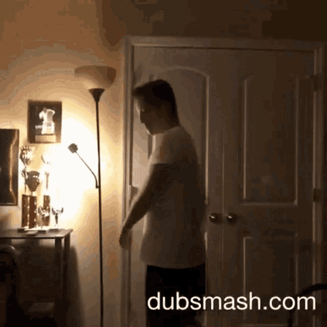 a man standing in a dark room with dubsmash.com written in the corner