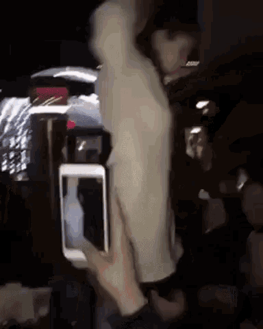 a person is taking a picture of a mannequin with a cell phone