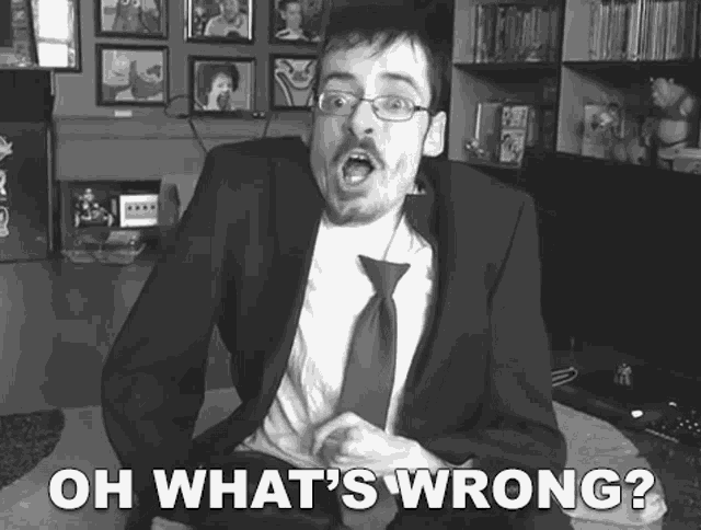 a man in a suit and tie says oh what 's wrong in a black and white photo