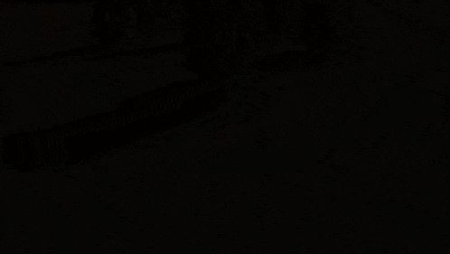 a group of men are riding motorcycles down the road