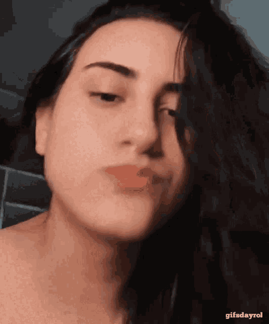 a close up of a woman 's face with the words gifsdayrol below