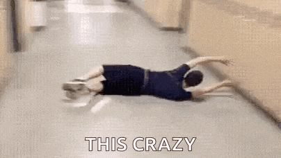 a person is laying on their back in a hallway next to a locker .
