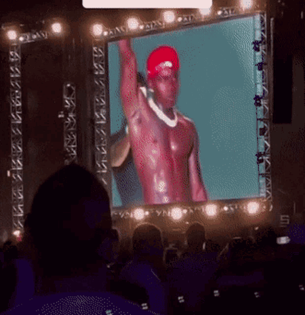 a man in a red hat is being projected on a screen
