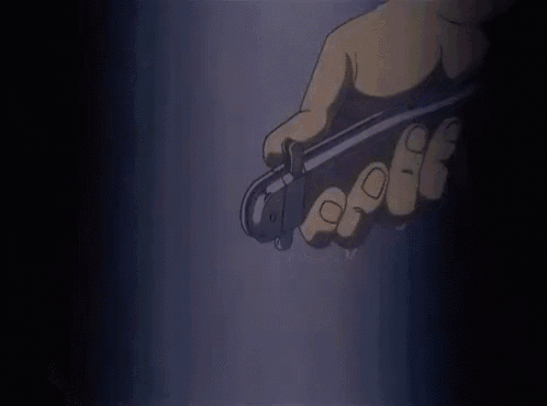a close up of a person 's hand holding a bottle of water in a dark room .
