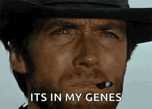 a man with a beard and a hat is smoking a cigar and saying `` it 's in my genes '' .